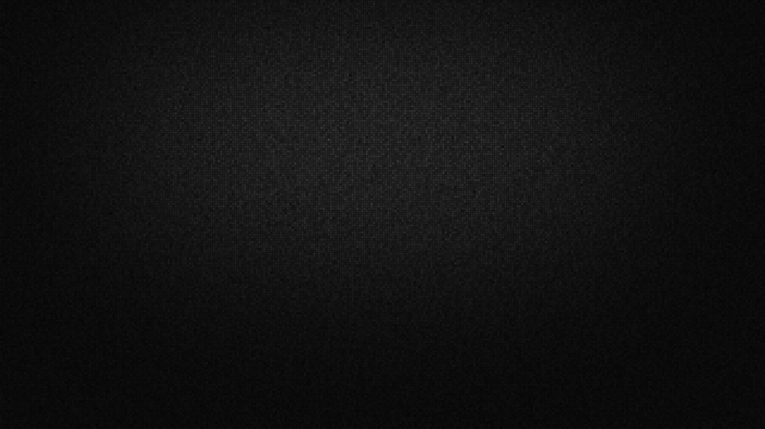 Dark textured surface with subtle lighting gradient