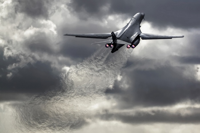 Rockwell B-1 Lancer bomber flying through clouds