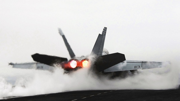 McDonnell Douglas FA-18 Hornet taking off from aircraft carrier