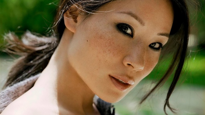Lucy Liu with freckles and dark eyes