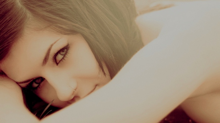 Brunette woman with striking eyes looking at viewer