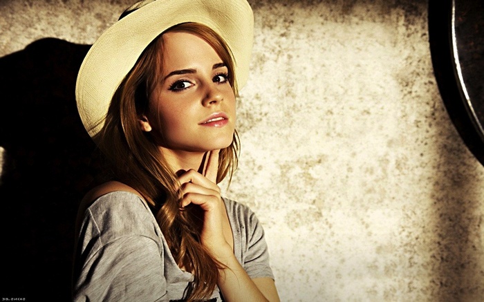 Emma Watson wearing a hat and grey shirt
