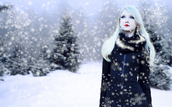 Blonde woman in a snowy forest