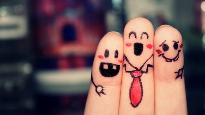 Three fingers with faces drawn on them