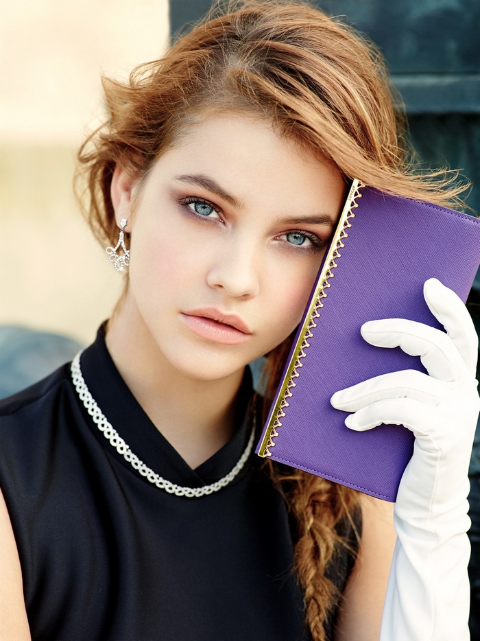 Barbara Palvin holding a purple notebook