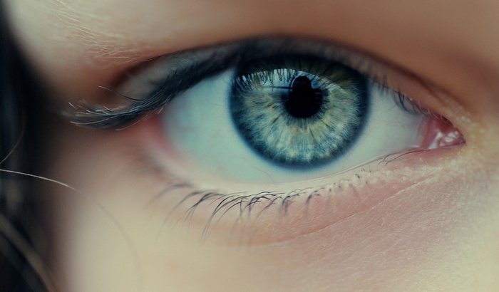 Close-up of a blue eye with eyelashes
