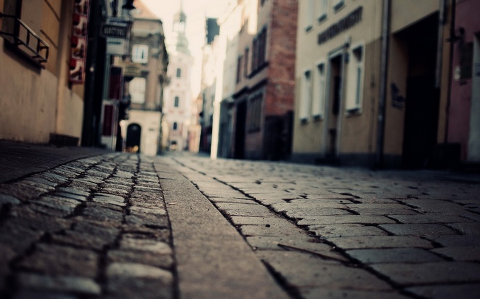 Cobblestone street with buildings and depth of field