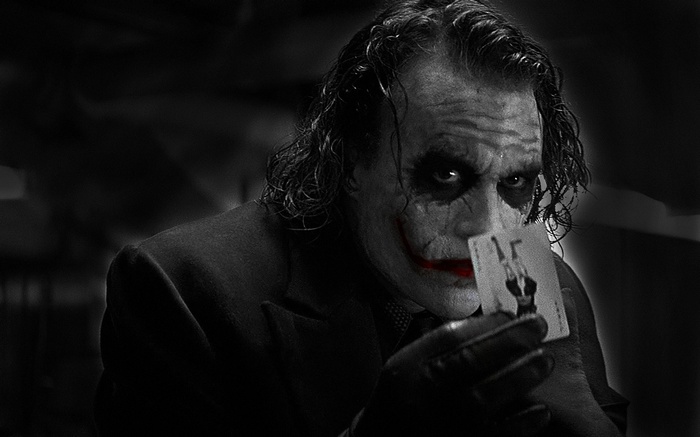 The Joker holding a playing card