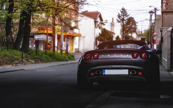 Dark Lotus car parked on a street