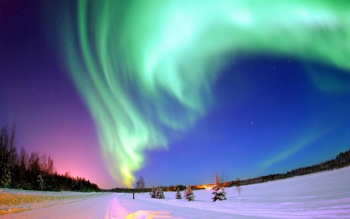 Aurora Borealis over a snowy winter landscape