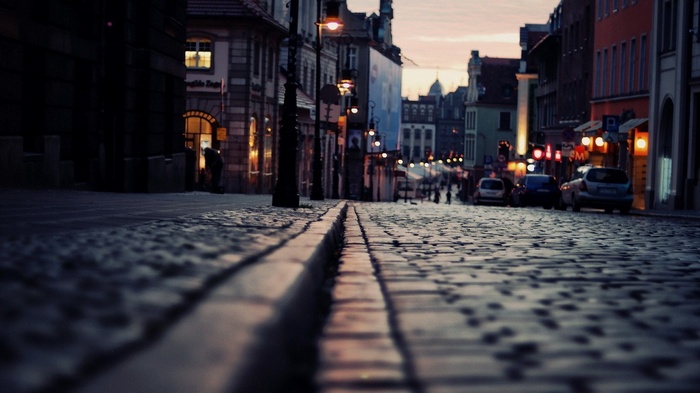 Cobblestone street in Poznan, Poland at dusk