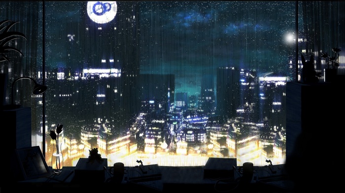 Rainy cityscape at night seen through a window