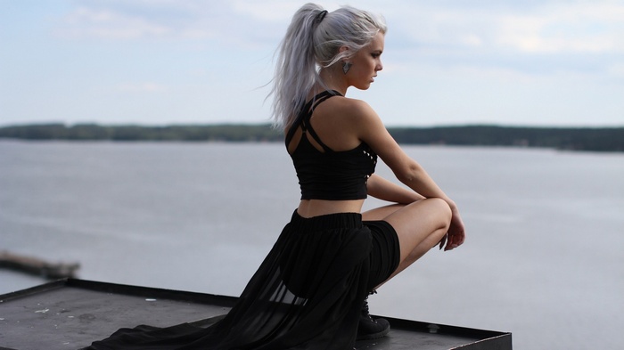 Miranda Hedman with platinum blonde hair on a rooftop