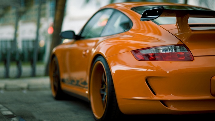 Orange Porsche 911 GT3 parked on a street