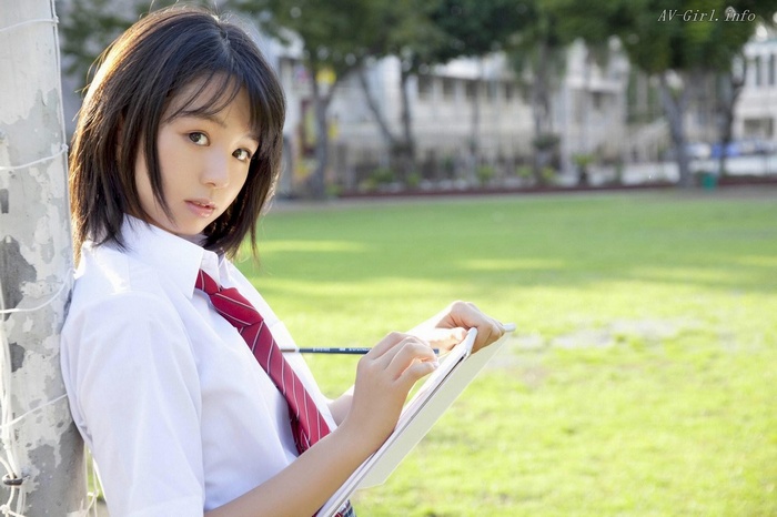 Rina Koike in school uniform writing
