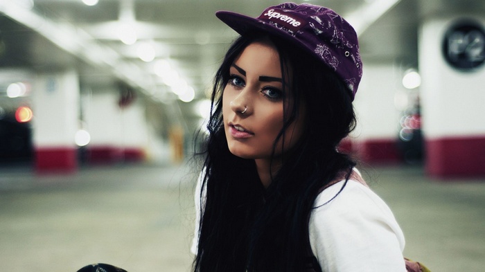 Danielle Mansutti wearing a Supreme hat in a parking garage
