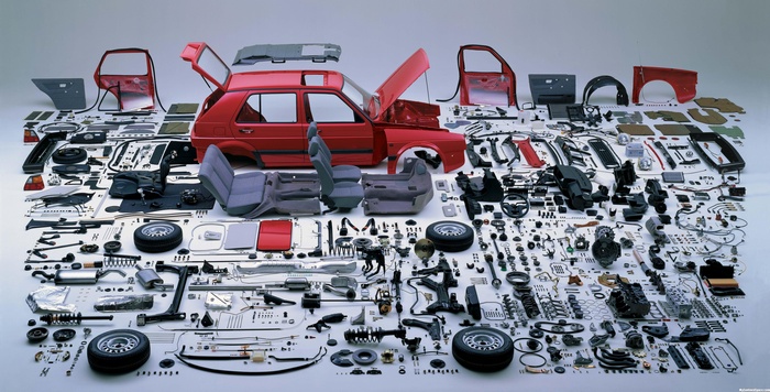 Disassembled red Volkswagen Golf GTI parts laid out
