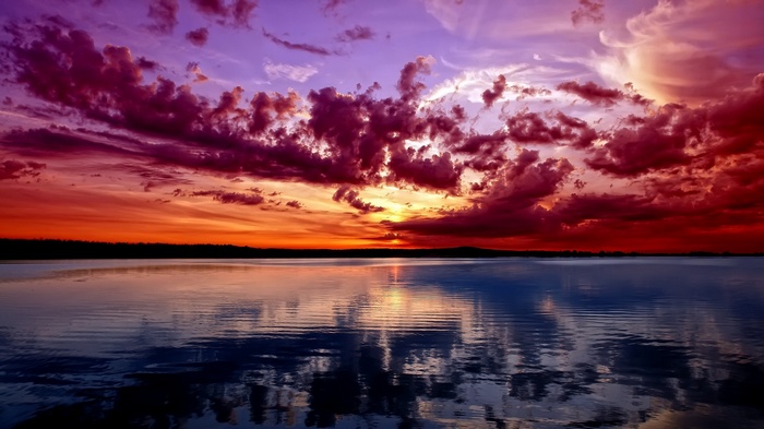 Sunset over a calm lake with colorful clouds