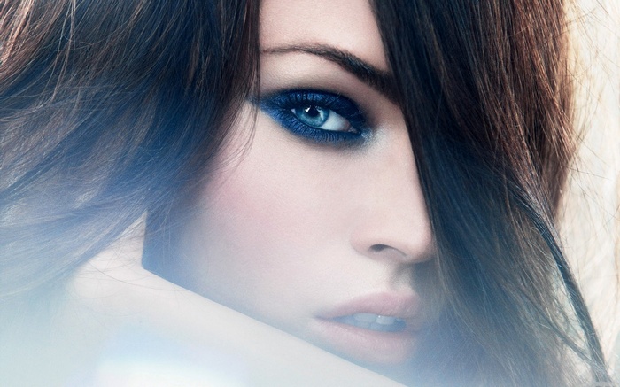 Megan Fox with blue eyeshadow and dark hair