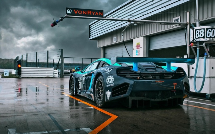 McLaren race car with number 60 on a wet track