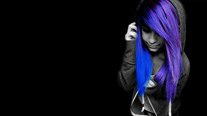 Woman with colorful hair in a hoodie