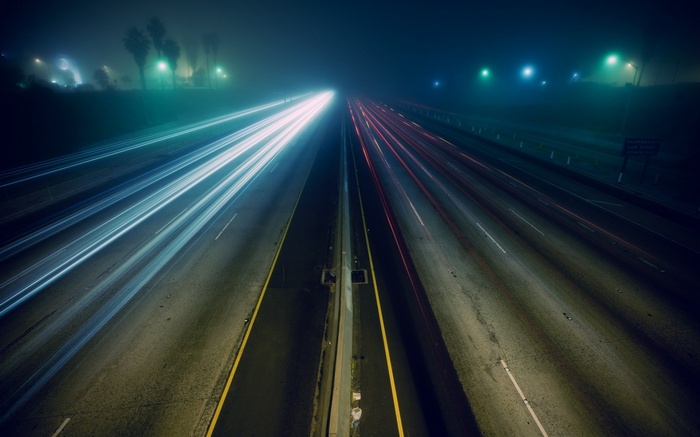 Long exposure of a highway at night with light trails