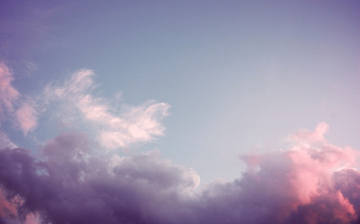 Purple and pink clouds in a blue sky