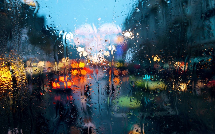 Cityscape lights through a rainy window