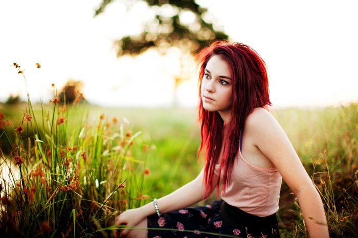 Tosha McCarter with red hair in a field