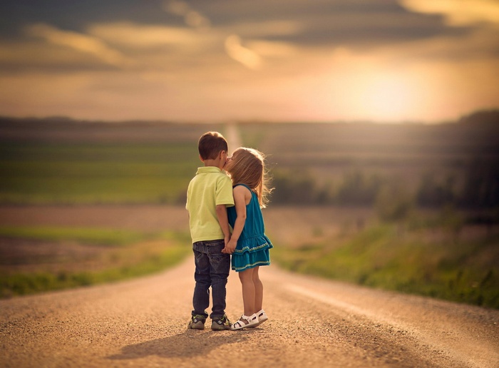 Children kissing on a road in Nebraska