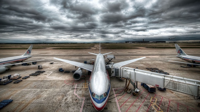 American Airlines airplanes at airport under cloudy sky