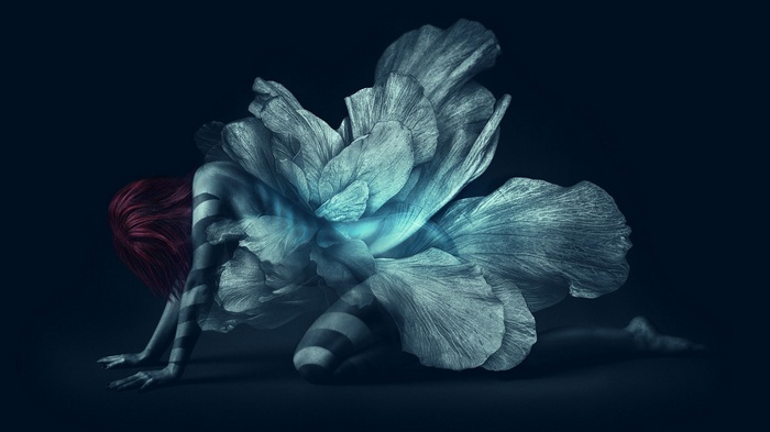 Woman with flower wings on dark background