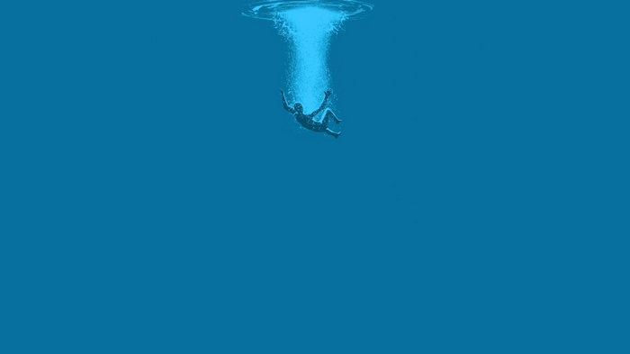 Man falling into deep blue water