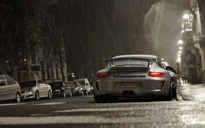 Porsche 911 GT3 parked on a rainy street at night