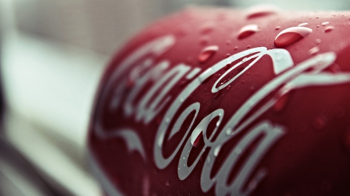 Close-up of a wet Coca-Cola can with water drops