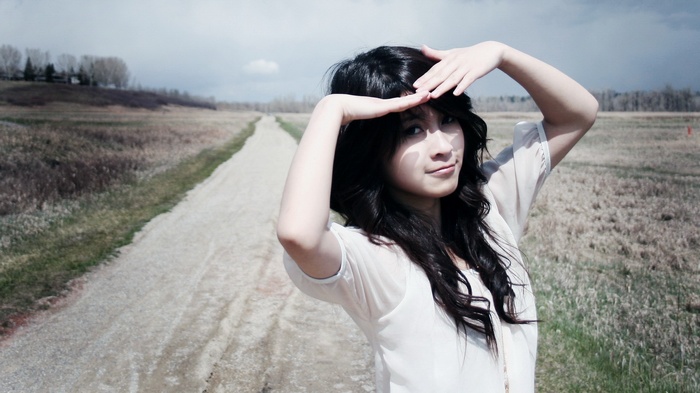 Asian woman with long hair in a field