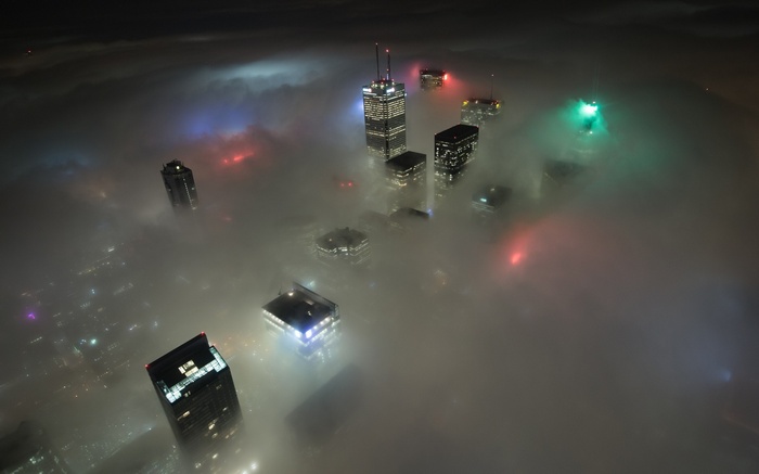 Toronto skyline shrouded in fog at night