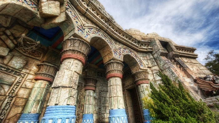 Ancient stone ruin with ornate columns and arches