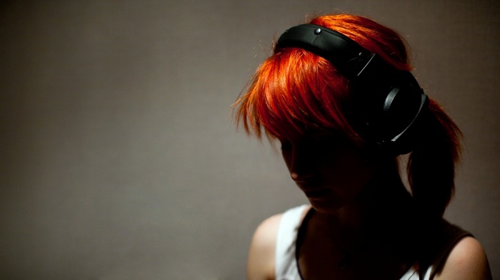 Woman with red hair wearing Beyerdynamic headphones