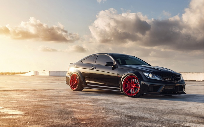 Black Mercedes-Benz C63 AMG with red rims