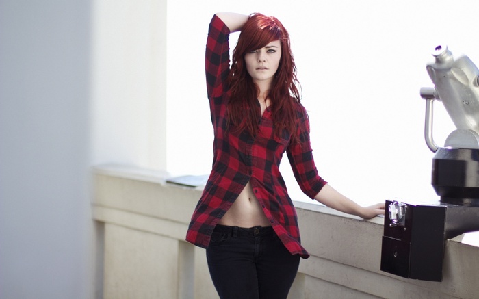 Redhead woman with hands on head