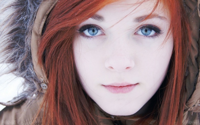 Young woman with red hair and blue eyes