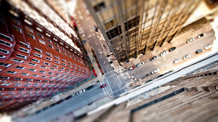 Aerial view of a city street with buildings and cars