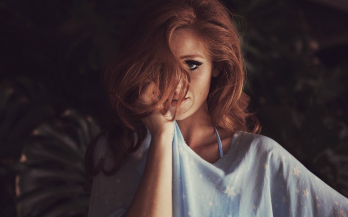 Cintia Dicker with red hair and blue shirt