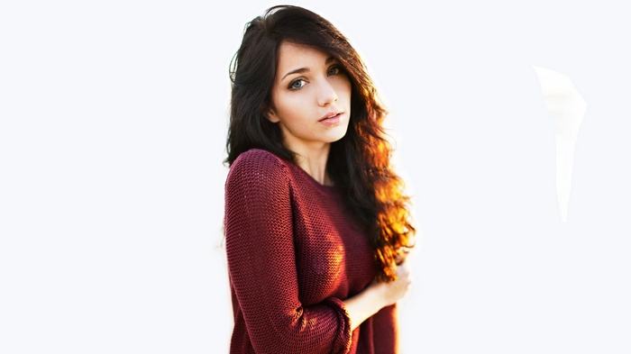 Emily Rudd in a maroon sweater with sunlight