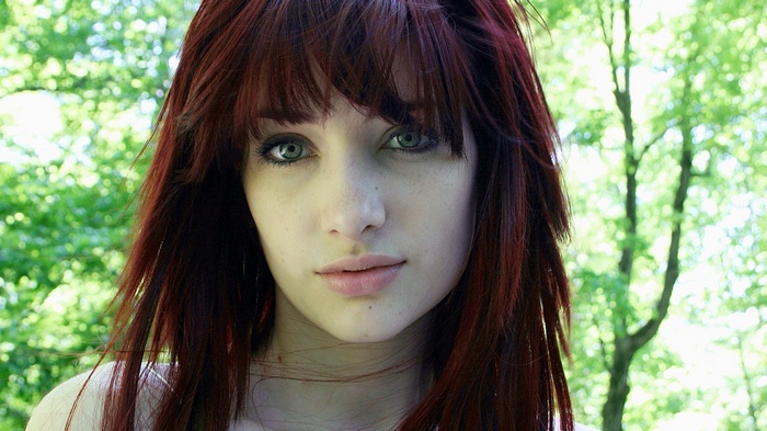 Susan Coffey with red hair looking at viewer