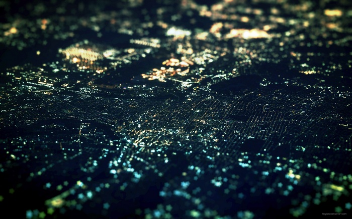 Aerial view of a city at night with tilt-shift effect