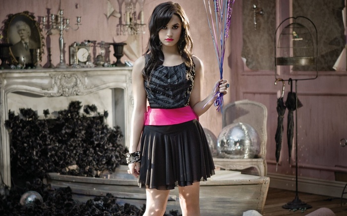 Demi Lovato holding balloons in a room