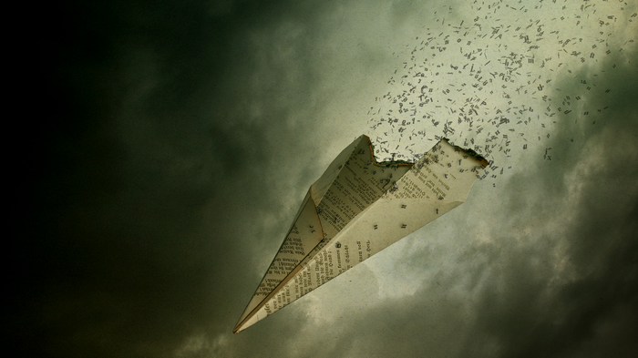 Paper airplane disintegrating into text