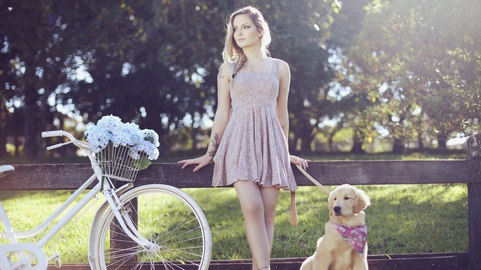 Woman with dog and bicycle with flowers